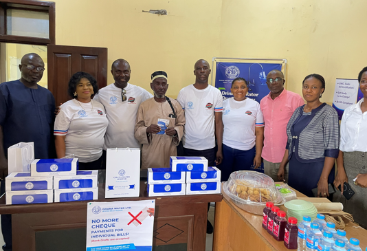 Staff Members in a pose with a Customer after their Engagement with him