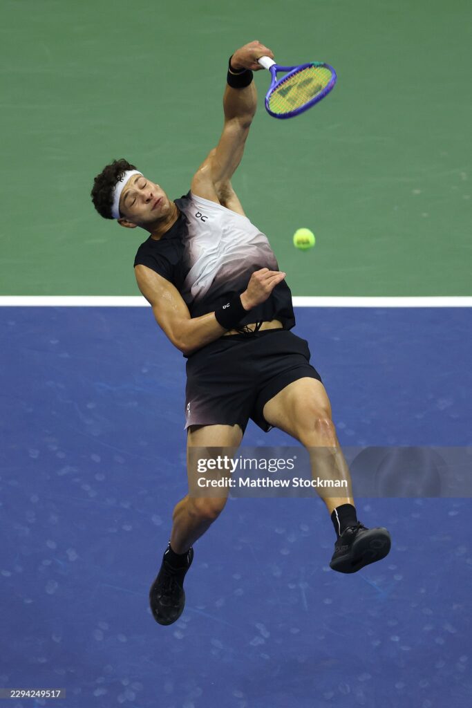NEW YORK, NEW YORK - SEPTEMBER 08: Ben Shelton of the United States returns a shot against Carlos Alcaraz of Spain during their Men's Singles Quarterfinal match on Day Ten of the 2026 US Open at USTA Billie Jean King National Tennis Center on September 08, 2026 in the Flushing neighborhood of the Queens borough of New York City.